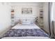 Comfortable bedroom with built-in shelving and soft, neutral bedding at 1922 E 18Th Ave, Denver, CO 80206