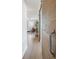 Hallway featuring a decorative sliding barn door leading to the living area with hardwood floors at 1922 E 18Th Ave, Denver, CO 80206