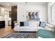 Bright living room featuring a modern white sofa, area rug, and statement artwork at 1922 E 18Th Ave, Denver, CO 80206