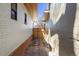 Narrow walkway between houses with stone tile and a wooden gate at the back at 1922 E 18Th Ave, Denver, CO 80206