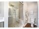 This bathroom features a glass shower, rain shower head, and built-in bench with neutral decor at 3126 Perry St, Denver, CO 80212