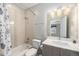 Well-lit bathroom with a combined bathtub/shower, vanity with marble countertop, and neutral finishes at 3126 Perry St, Denver, CO 80212