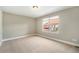 Cozy bedroom with neutral walls, carpet floors and a window showcasing the neighborhood at 3126 Perry St, Denver, CO 80212