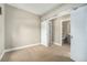 Bedroom with neutral walls, plush carpet floors and barn door leading to the bathroom at 3126 Perry St, Denver, CO 80212