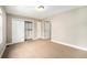 Spacious bedroom with neutral walls, carpet floors, closet, and two entry doors at 3126 Perry St, Denver, CO 80212