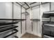 Bright walk-in closet with black metal storage shelves, hanging rods and a small window at 3126 Perry St, Denver, CO 80212