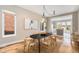 Inviting dining room featuring a modern light fixture, hardwood floors, and an open view to the kitchen at 3126 Perry St, Denver, CO 80212