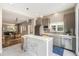 Modern kitchen with stainless steel appliances, a quartz countertop island with bar seating, and a neutral color scheme at 3126 Perry St, Denver, CO 80212