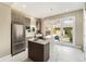 Bright kitchen featuring stainless steel appliances, quartz countertops, a kitchen island, and access to an outdoor patio at 3126 Perry St, Denver, CO 80212