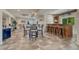 Large basement with tiled floor, bar with stools, table and chairs, and well-lit space at 580 Eagle Nest Ct, Golden, CO 80401