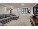 Comfortable basement living area featuring a large sectional couch and artwork at 580 Eagle Nest Ct, Golden, CO 80401