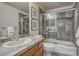 Bathroom featuring tile surround, glass shower door, neutral tones, and modern fixtures at 580 Eagle Nest Ct, Golden, CO 80401