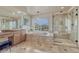 Elegant bathroom featuring dual sinks, a soaking tub, a glass shower, and tiled flooring at 580 Eagle Nest Ct, Golden, CO 80401