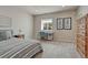 Cozy bedroom with neutral colors, carpet floors, desk with natural light, and furnishings at 580 Eagle Nest Ct, Golden, CO 80401