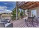 Outdoor deck with seating, view of the area, and stone pillars at 580 Eagle Nest Ct, Golden, CO 80401