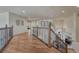 Open second floor hallway with wood floors, decorative railing and views to the entry at 580 Eagle Nest Ct, Golden, CO 80401