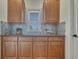 Butler's pantry complete with elegant cabinetry, countertop, and decorative backsplash to make it pop at 580 Eagle Nest Ct, Golden, CO 80401