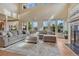 Bright living room with soaring ceilings, large windows, and a cozy fireplace at 580 Eagle Nest Ct, Golden, CO 80401
