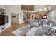 Open-concept living room featuring a large sectional sofa, hardwood floors, and a staircase to the upper level at 580 Eagle Nest Ct, Golden, CO 80401