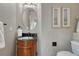 Charming powder room with a decorative vanity, mirror, and neutral tones at 580 Eagle Nest Ct, Golden, CO 80401