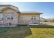 The backyard has a small patio, a window, and the lower portion of the house is made of stone at 6760 Meade Cir # C, Westminster, CO 80030