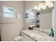 Bright bathroom featuring granite countertops, a white vanity, and a well-lit mirror at 6760 Meade Cir # C, Westminster, CO 80030
