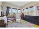Bright Bedroom with crib, soft chair, and colorful alphabet rug under natural light at 6760 Meade Cir # C, Westminster, CO 80030