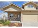 Charming home featuring stone accents, a covered porch, and a well-maintained front yard at 6760 Meade Cir # C, Westminster, CO 80030