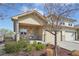 Charming home exterior showcasing a well-kept lawn, stone accents, covered porch, and a two-car garage at 6760 Meade Cir # C, Westminster, CO 80030