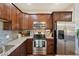 Well-equipped kitchen with stainless steel appliances, tile backsplash, and granite countertops at 6760 Meade Cir # C, Westminster, CO 80030