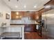 Modern kitchen with stainless steel appliances, granite countertops, and dark wood cabinetry at 6760 Meade Cir # C, Westminster, CO 80030