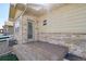 Exterior view of the patio, the back entrance of the house, with an exterior made of stone at 6760 Meade Cir # C, Westminster, CO 80030