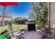 Well-maintained backyard patio area with a stainless steel grill and outdoor seating at 18655 E Garden Pl, Aurora, CO 80015