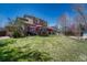 Expansive backyard with lush green grass, a wooden deck, and a red umbrella for outdoor relaxation at 18655 E Garden Pl, Aurora, CO 80015