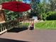 A red umbrella offers deck shade overlooking the backyard at 18655 E Garden Pl, Aurora, CO 80015