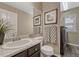 Well-lit bathroom that includes a sink, a toilet, and laundry machines at 18655 E Garden Pl, Aurora, CO 80015