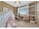Adorable bedroom with built-in bookshelves, window seating, and a cozy tent at 18655 E Garden Pl, Aurora, CO 80015