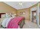 Cozy bedroom featuring a comfortable bed, soft carpet, and convenient access to the hallway at 18655 E Garden Pl, Aurora, CO 80015