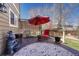 Inviting patio area with a red umbrella and an outdoor rug, perfect for relaxing outdoors at 18655 E Garden Pl, Aurora, CO 80015