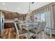 Stylish dining area features modern light fixture, hardwood floors, and dark cabinetry at 18655 E Garden Pl, Aurora, CO 80015