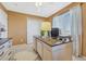 Functional home office space with a large desk, built-in storage, and bright window at 18655 E Garden Pl, Aurora, CO 80015