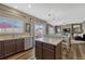 Modern kitchen with island, stainless steel appliances, and open layout flowing into the living room at 18655 E Garden Pl, Aurora, CO 80015
