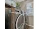 Convenient laundry area with a front-load washer and dryer set and shelving at 18655 E Garden Pl, Aurora, CO 80015