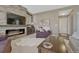 Comfortable living space with a brick fireplace, a TV, and neutral-toned furniture at 18655 E Garden Pl, Aurora, CO 80015