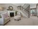 Inviting living room featuring a fireplace, plush seating, and a staircase leading to the upper level at 18655 E Garden Pl, Aurora, CO 80015