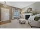 Comfortable living room features a fireplace, armchairs, ottoman, and a view to the front door at 18655 E Garden Pl, Aurora, CO 80015