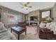 Inviting living room featuring a ceiling fan, a brick fireplace, and lots of natural light at 18655 E Garden Pl, Aurora, CO 80015