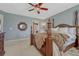 Spacious main bedroom featuring a ceiling fan, plush carpet, and large decorative mirror at 18655 E Garden Pl, Aurora, CO 80015