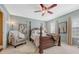 Serene main bedroom featuring a wooden four-poster bed and plenty of natural light at 18655 E Garden Pl, Aurora, CO 80015