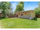 Landscaped backyard with green lawn and outdoor structure with hanging lights at 3177 S Grant St, Englewood, CO 80113